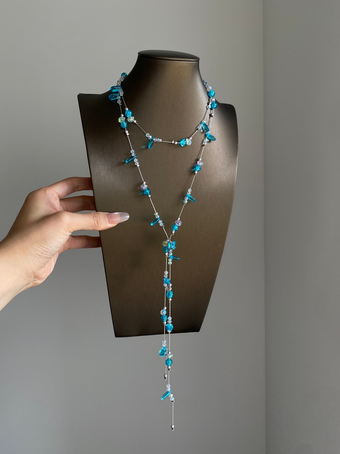 Silver-tone aqua lariat necklace styled with lace and soft white outfit