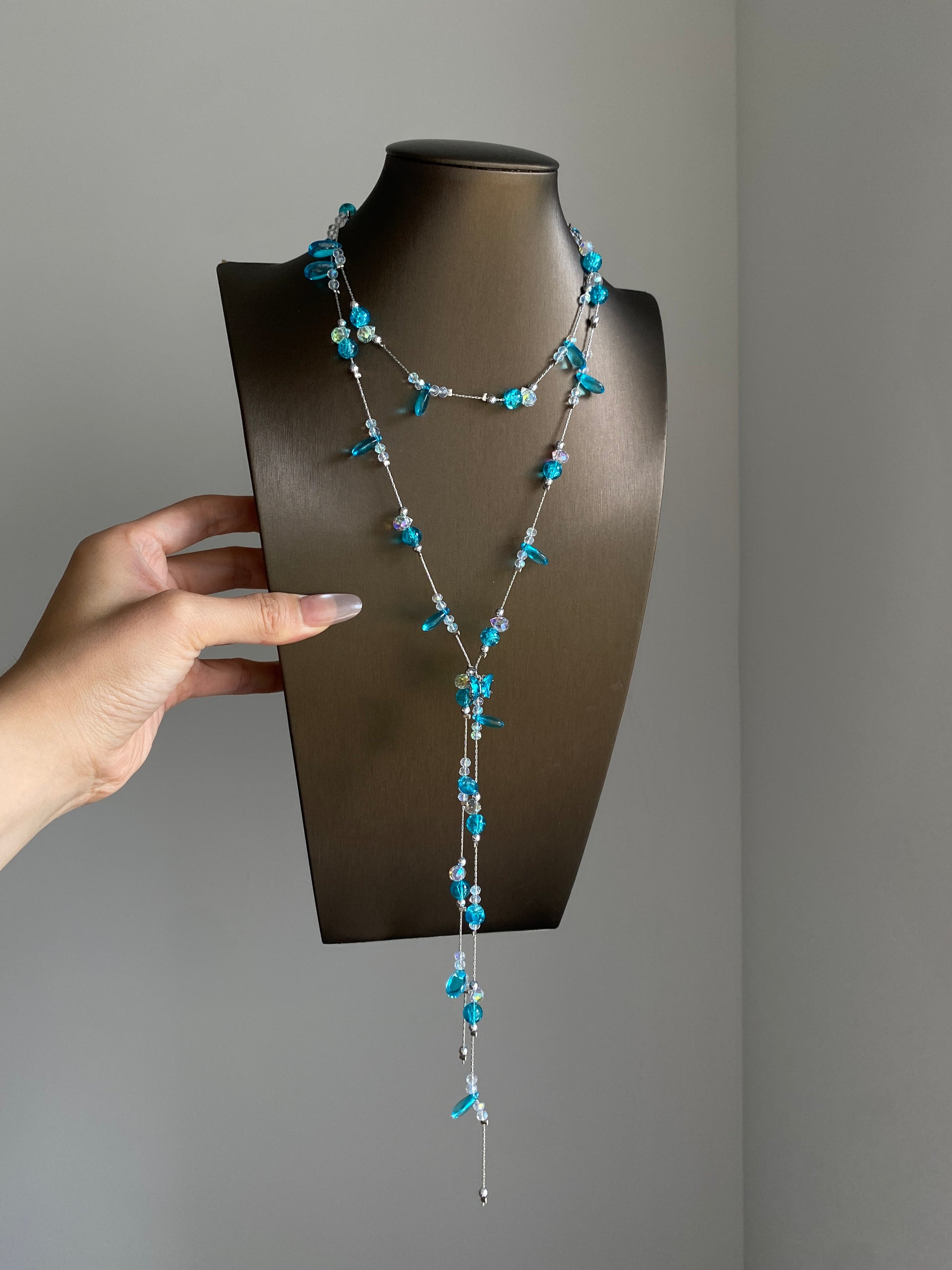 Silver-tone aqua lariat necklace styled with lace and soft white outfit