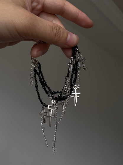 Gothic cross bracelet with black faceted beads and dangling chain tassels