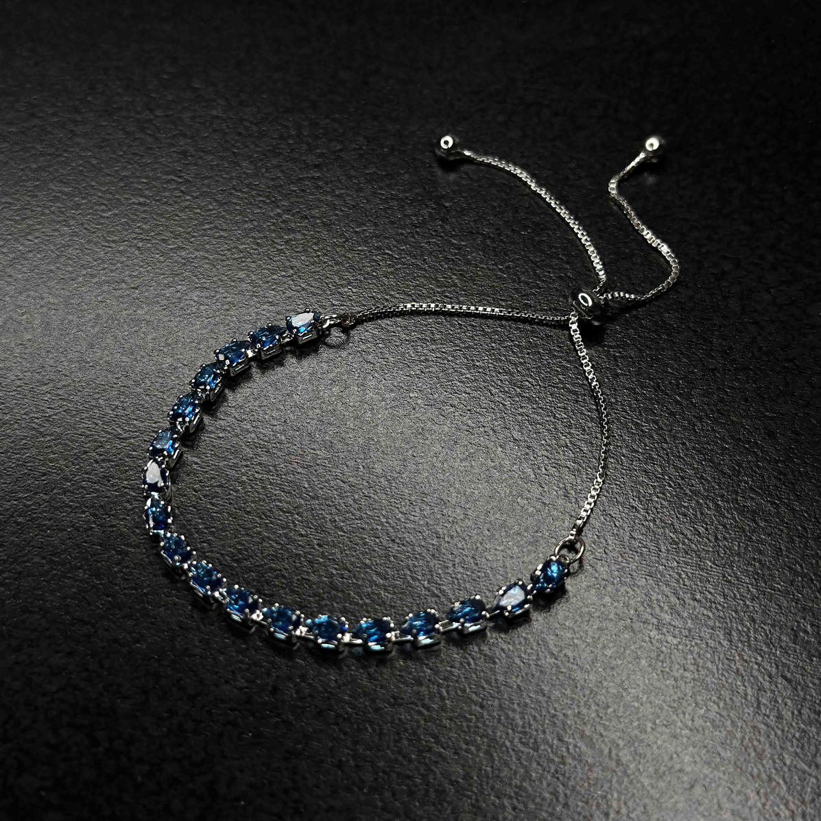 Blue gemstone bolo bracelet with silver-tone chain and adjustable sliding closure
