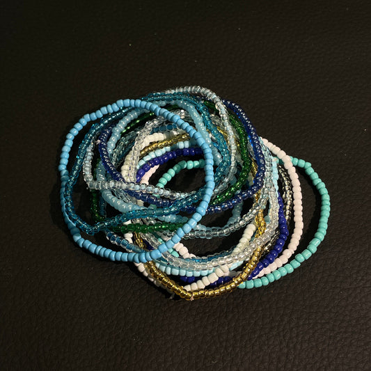 Blue green beaded bracelet set with stacked aqua, teal, clear, and white seed beads