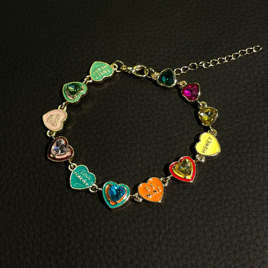 Colorful heart charm bracelet with gold-tone links and enamel-style candy hearts