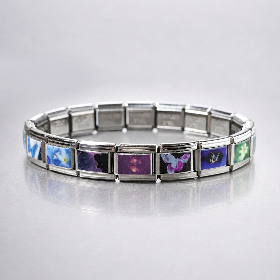 Dreamcore modular bracelet with soft butterfly signals and retro internet imagery