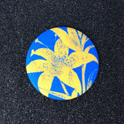 Electric lily flash pocket mirror with blue background and yellow floral print