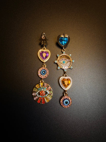 Mystical evil eye dangle earrings with symbolic charms and vintage mood