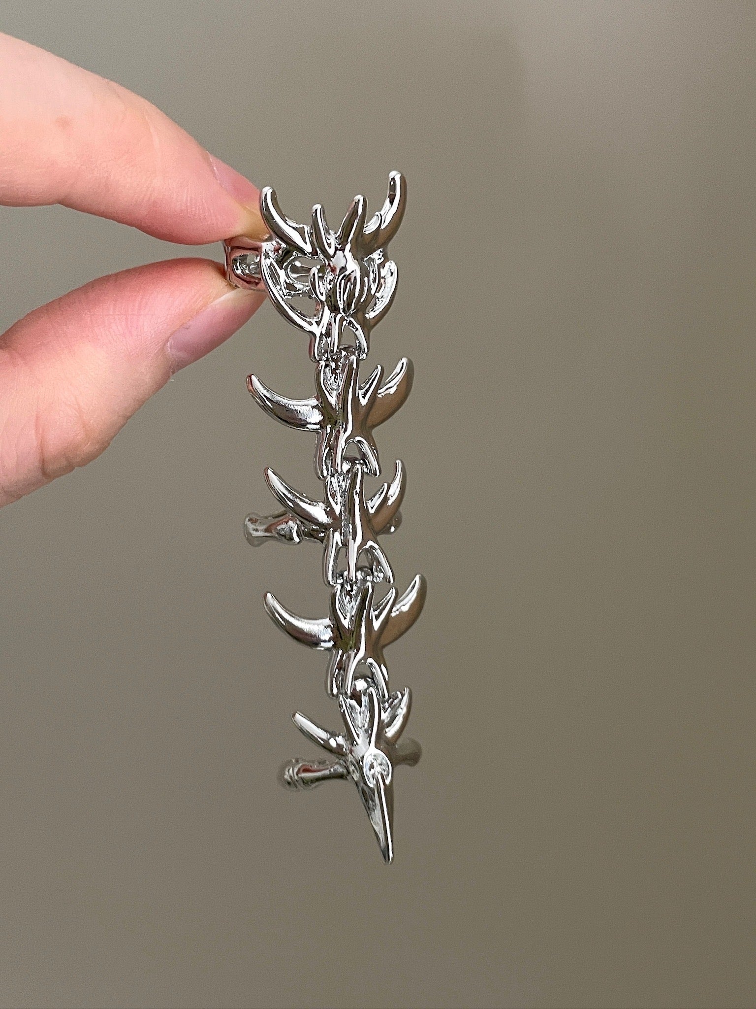 Y2K silver armor ring with sharp thorn details and dramatic statement shape