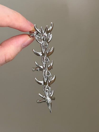 Y2K silver armor ring with sharp thorn details and dramatic statement shape