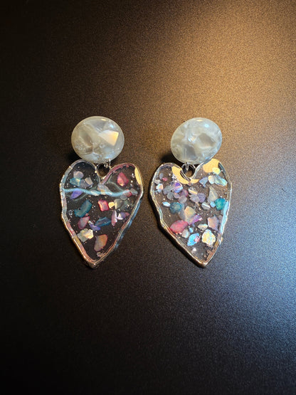 Holographic clear heart earrings with colorful confetti-like details inside