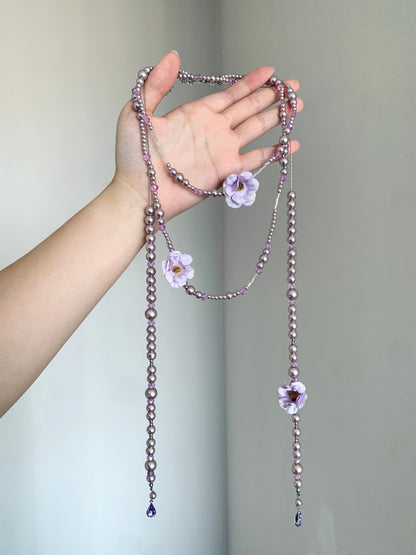 Purple beaded flower necklace styled on display bust with fairycore Y2K mood