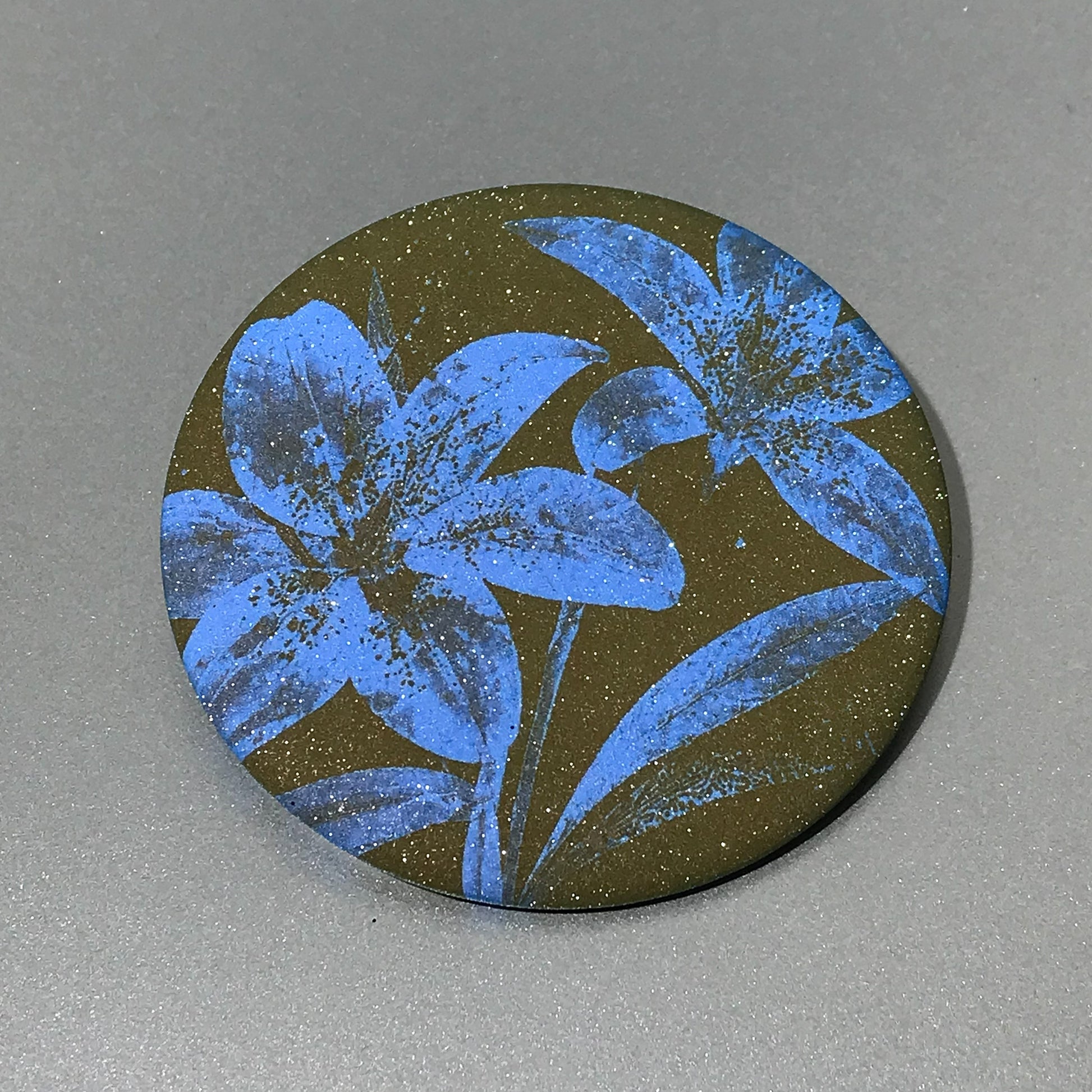 Round pocket mirror with moss green and blue botanical artwork