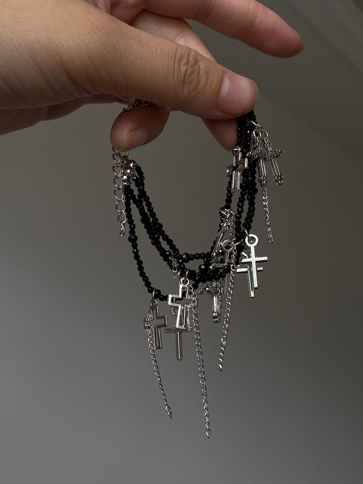 Y2K black beaded bracelet with silver-tone cross charms and layered structure