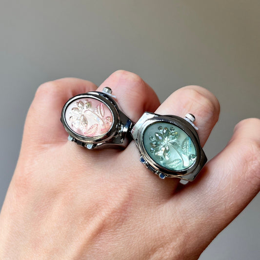 Palm tree watch ring with silver-tone frame and pastel pink and mint faces