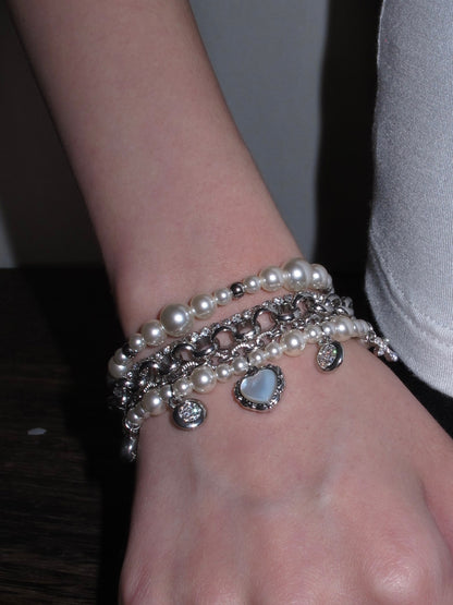 Coquette layered bracelet with faux pearl beads, crystal sparkle, and heart charm