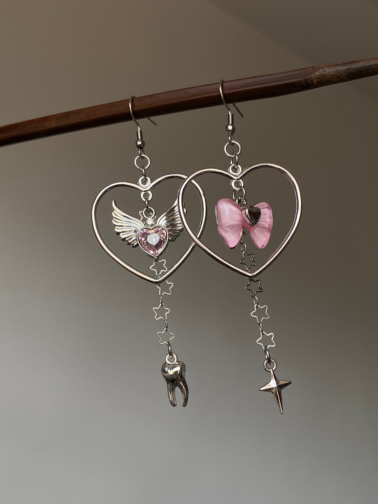 Pink bow heart charm earrings with asymmetrical Y2K dangle silhouette 