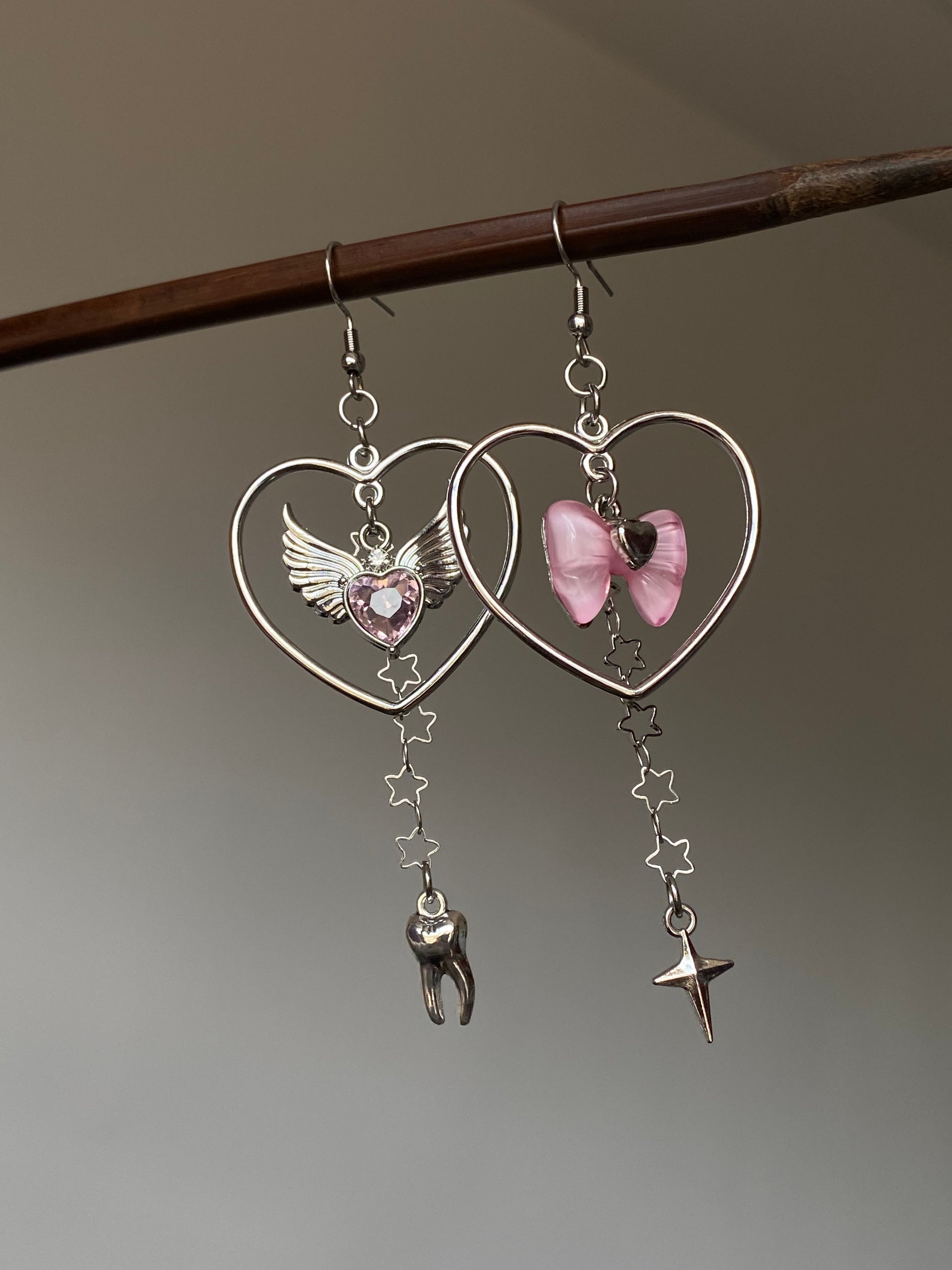 Pink bow heart charm earrings with asymmetrical Y2K dangle silhouette 