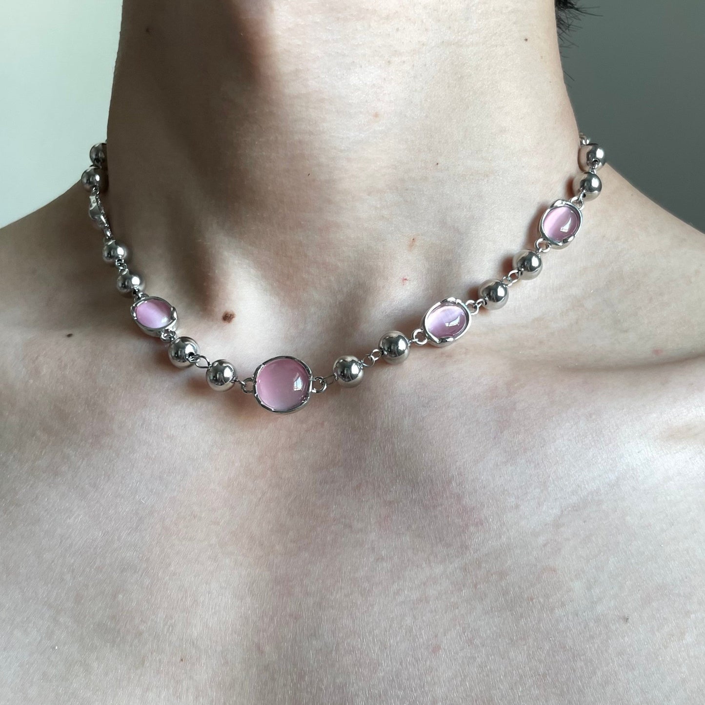 Pink cat eye bead choker with silver-tone beads and soft dreamcore mood