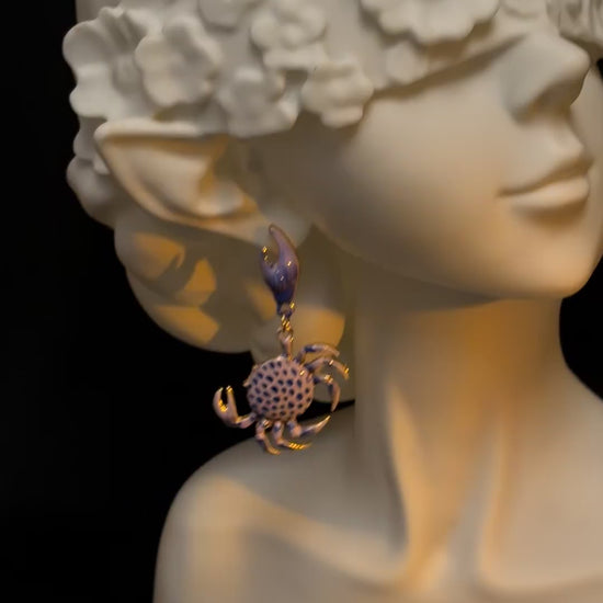 Y2K blue crab earrings with lifted claw shape and coastal styling mood