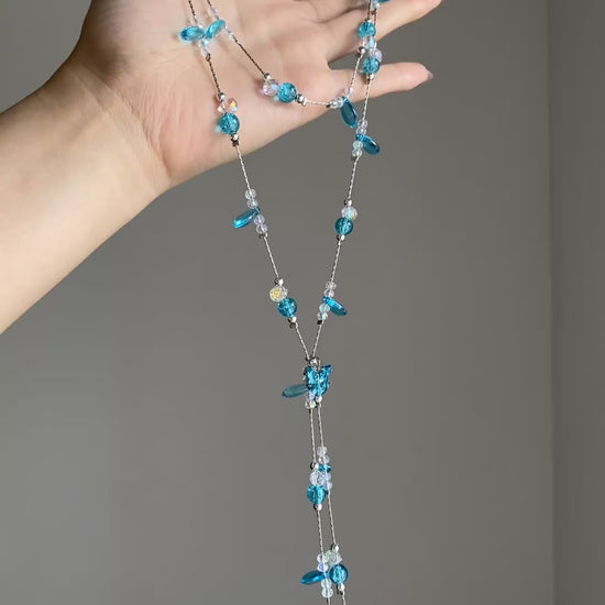 Cascading aqua bead necklace with clear accents and multi-layer collarbone shape