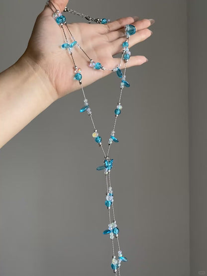 Cascading aqua bead necklace with clear accents and multi-layer collarbone shape