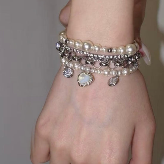 Y2K pearl chain bracelet with heart charm and layered silver-tone bracelet stack