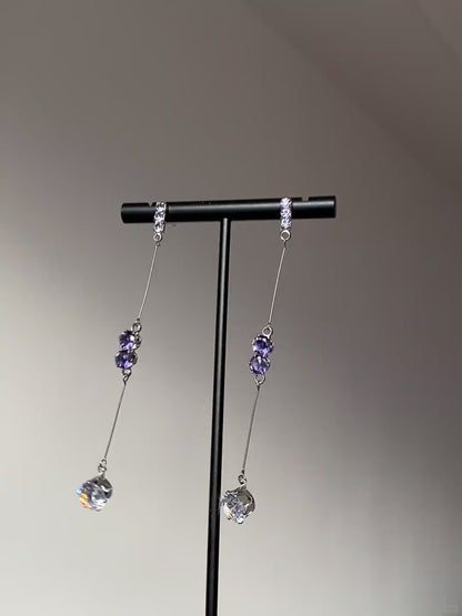 Clear teardrop crystal earrings with purple stones and silver-tone metal details