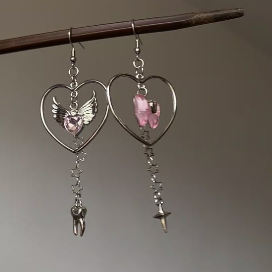 Silver-tone heart dangle earrings with layered charms and dreamcore styling mood