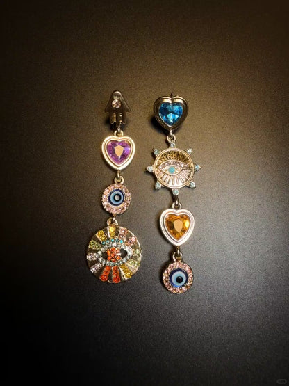 Asymmetrical dangle charm earrings styled for soft grunge and Y2K jewelry looks