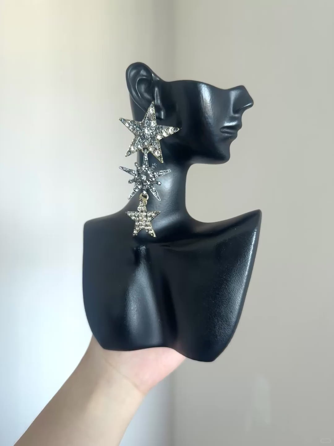 Celestial rhinestone earrings with layered star shapes and dramatic dangle design