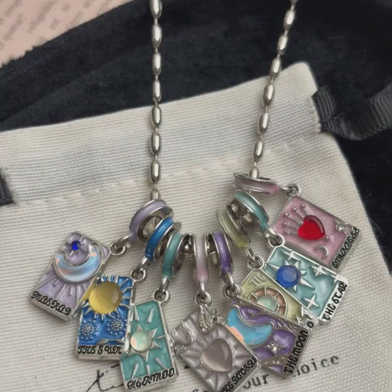 Colorful tarot-card-style necklace with moon, star, heart, and sun charms