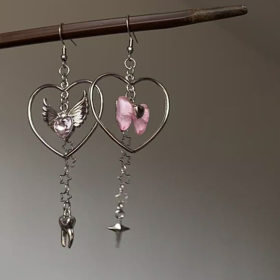 Y2K silver-tone dangle earrings with heart frame, winged heart, and star chain details