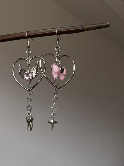 Y2K silver-tone dangle earrings with heart frame, winged heart, and star chain details