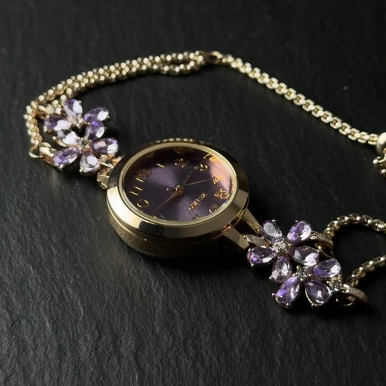 Adjustable watch bracelet with purple face, flower accents, and small crystal end charm