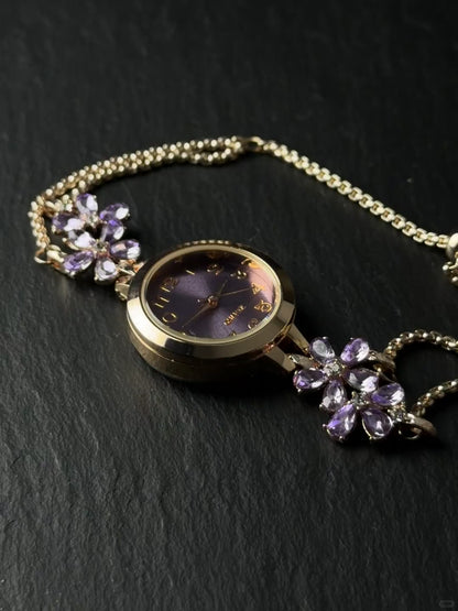 Adjustable watch bracelet with purple face, flower accents, and small crystal end charm
