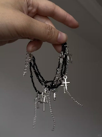 Soft grunge cross bracelet with black bead strands and silver-tone details