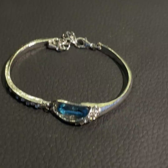 Silver-tone blue crystal bracelet with small clear rhinestone-style details