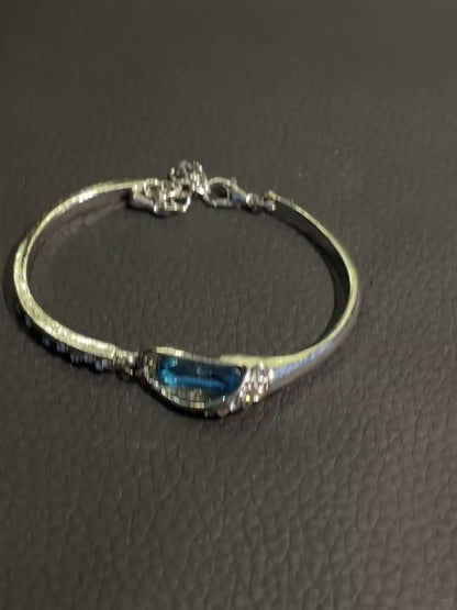 Silver-tone blue crystal bracelet with small clear rhinestone-style details