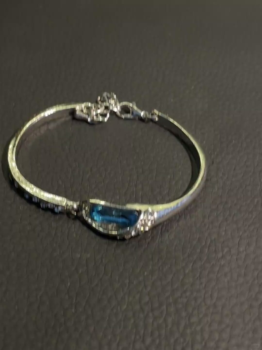 Silver-tone blue crystal bracelet with small clear rhinestone-style details