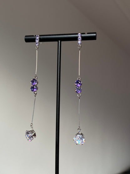 Silver-tone purple crystal dangle earrings with paired purple stones and clear drops