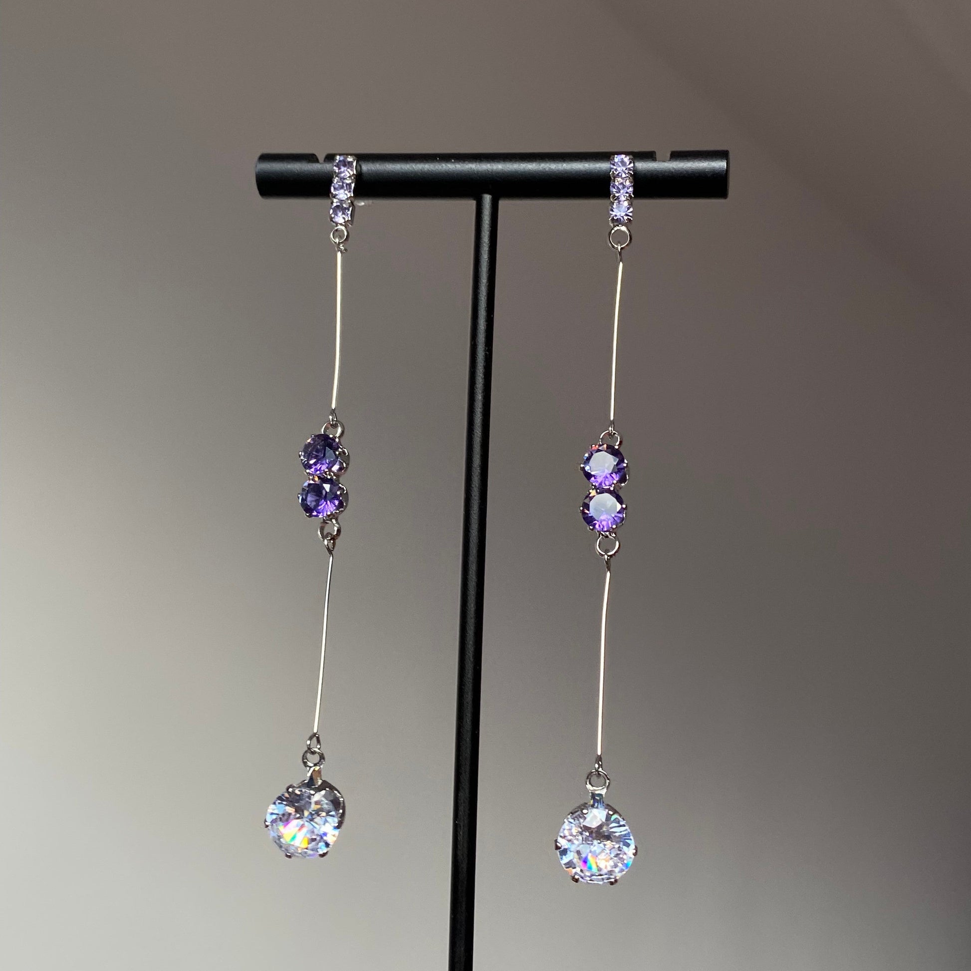Purple crystal teardrop dangle earrings with silver-tone bar links and clear faceted drops