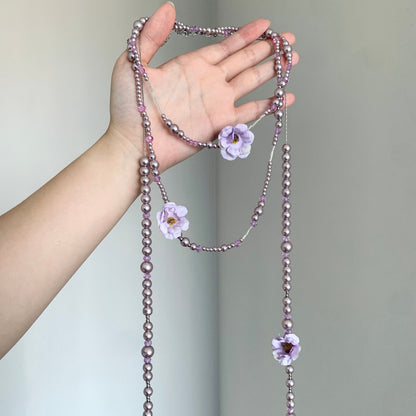 Purple floral beaded lariat necklace with lavender faux pearl-style beads and flower charms