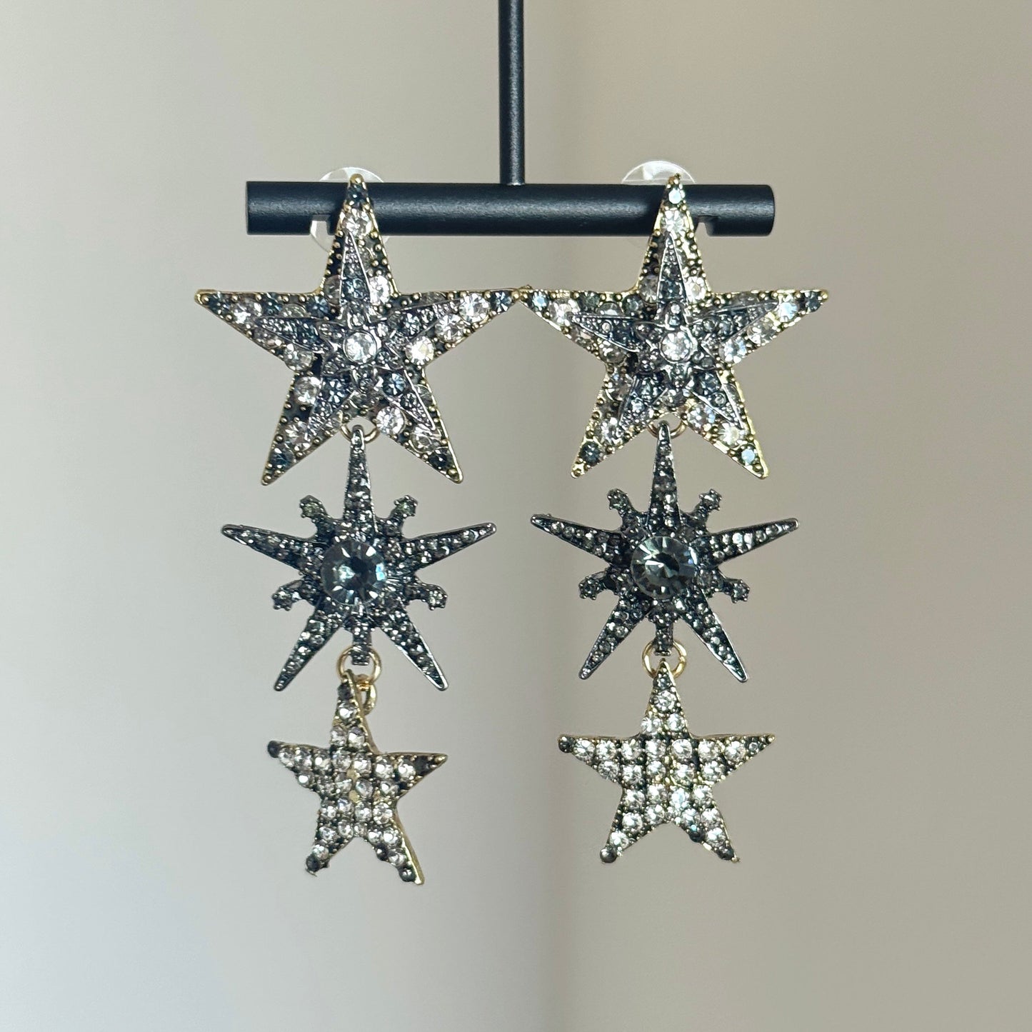 Rhinestone star dangle earrings with silver-tone setting and layered crystal stars
