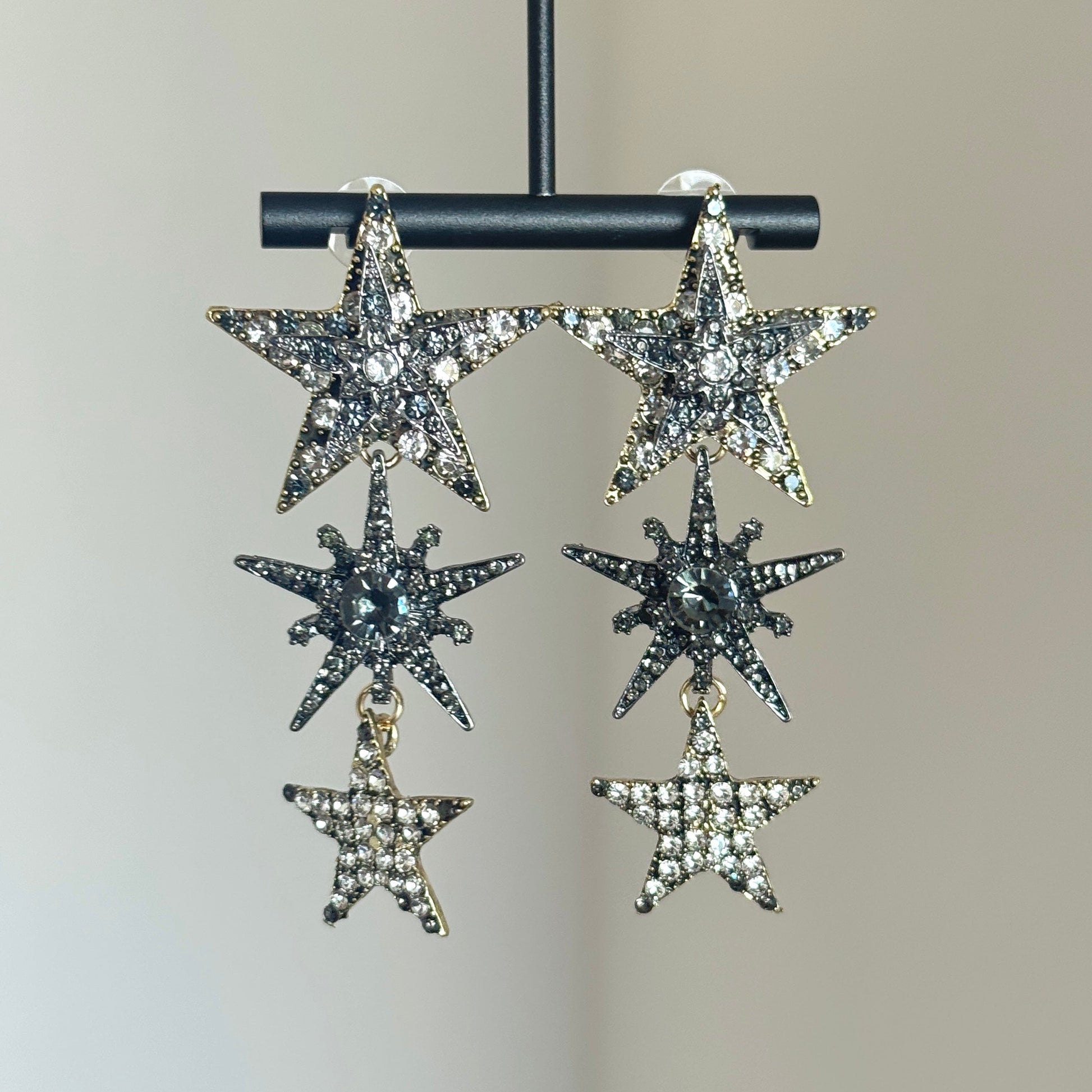 Rhinestone star dangle earrings with silver-tone setting and layered crystal stars