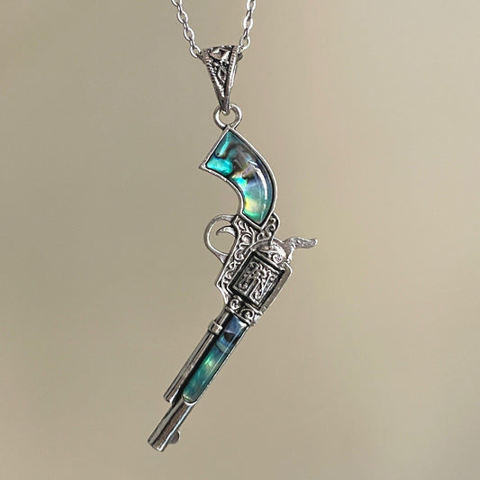 Shell inlay revolver pendant necklace with silver-tone chain and ornate gun details