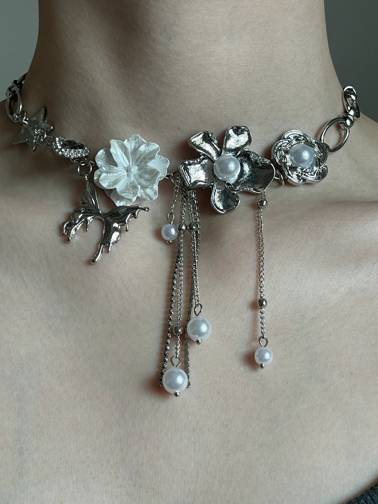 Silver-tone floral choker with star charm, flower charms, and soft grunge styling mood