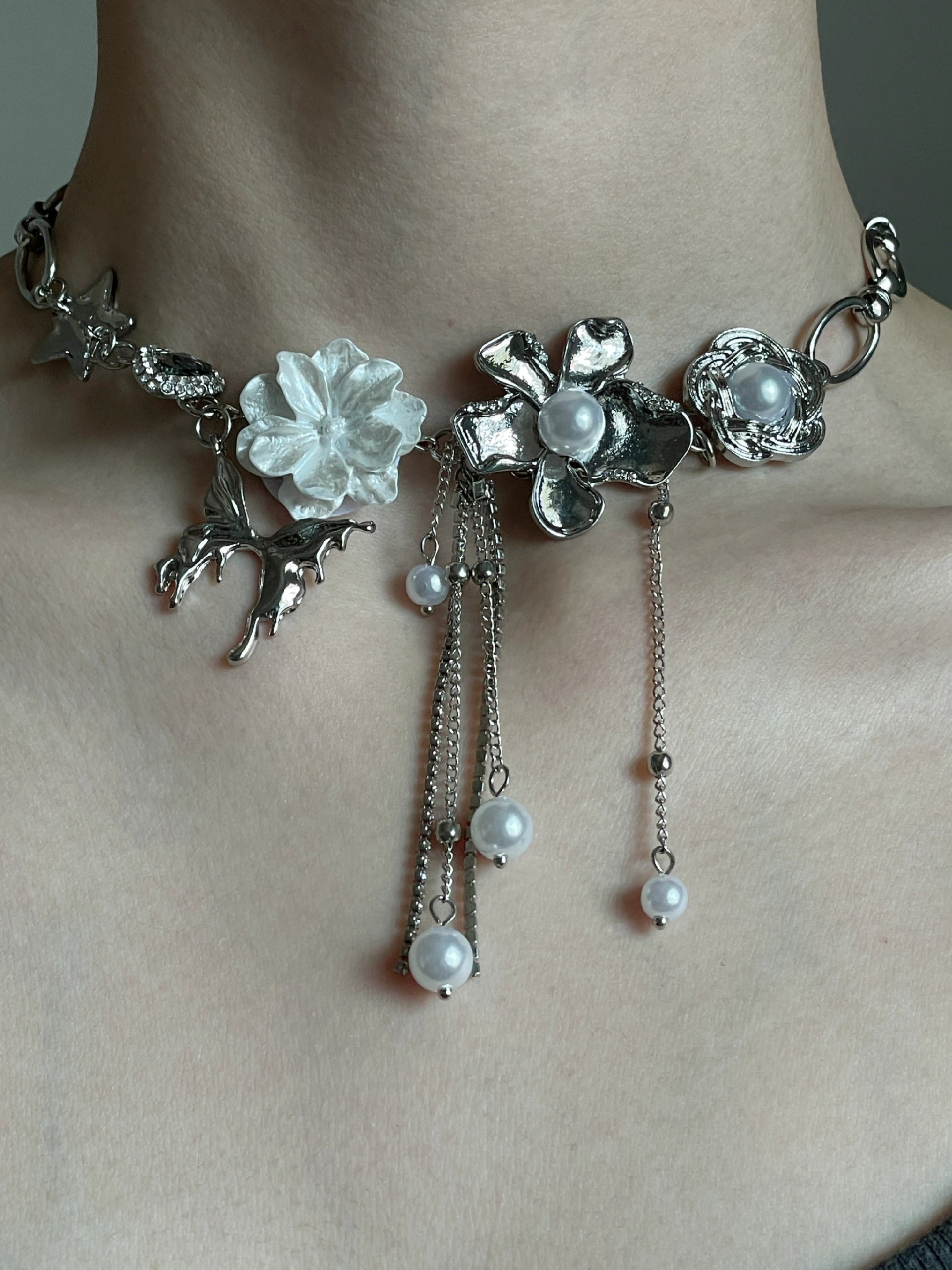 Silver-tone floral choker with star charm, flower charms, and soft grunge styling mood