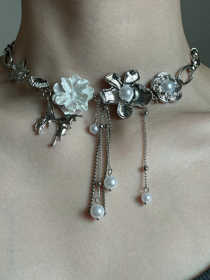 Silver-tone floral choker with star charm, flower charms, and soft grunge styling mood