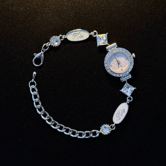 Silver watch charm bracelet with functional round watch and clear crystal accents