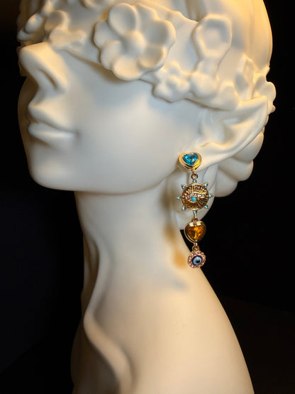 Y2K asymmetrical charm earrings with evil eye, heart, and hand charm details